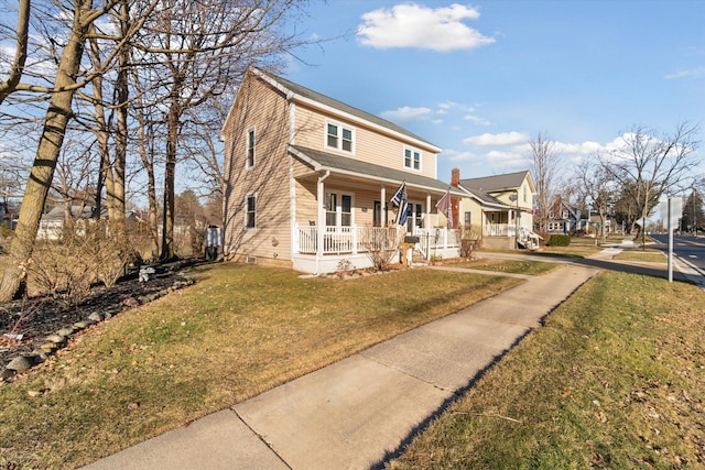 view of front of house with a front yard and covered porch