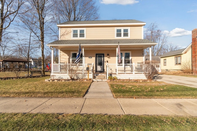 bungalow-style house with covered porch, a front lawn, and a shingled roof