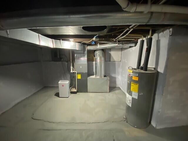 unfinished below grade area with water heater and heating unit