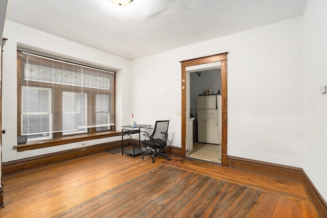 office area with wood-type flooring and baseboards