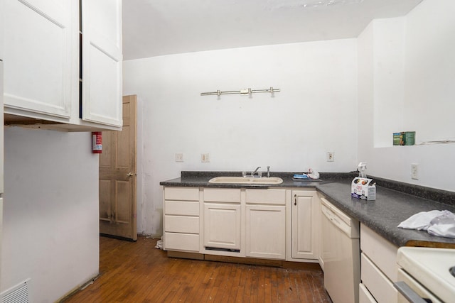 kitchen featuring dark countertops, dark wood-style flooring, white dishwasher, and a sink