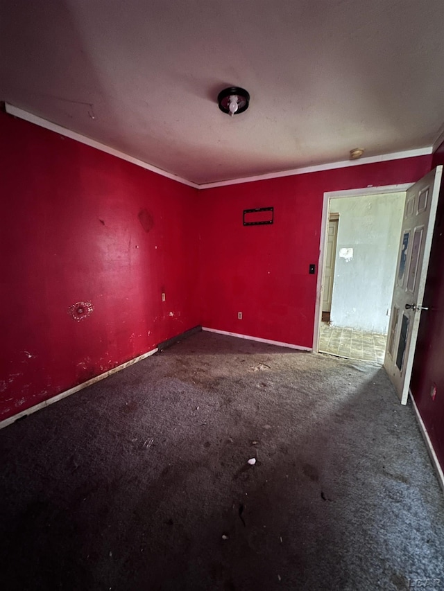 carpeted spare room with baseboards and ornamental molding