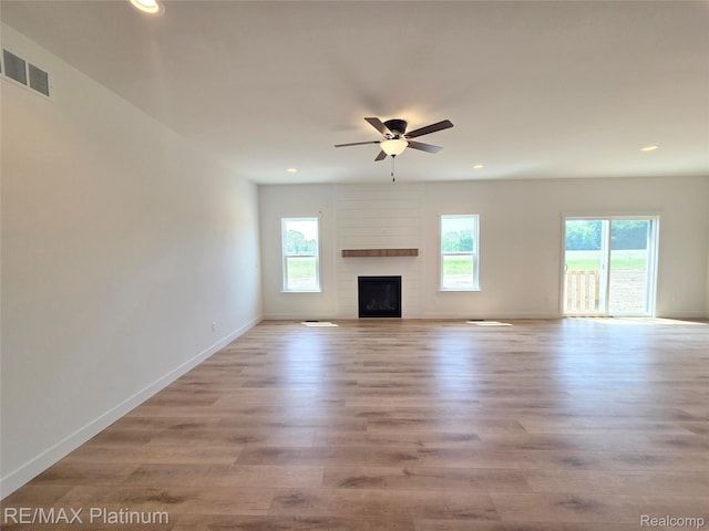 13059 River Rock Pass, Linden, MI 48451 - unfurnished living room featuring a ceiling fan, recessed lighting, baseboards, wood finished floors, and a fireplace