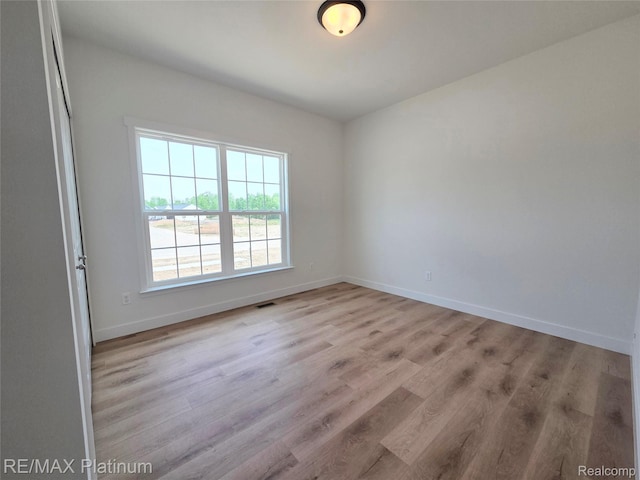 13059 River Rock Pass, Linden, MI 48451 - empty room with wood finished floors and baseboards
