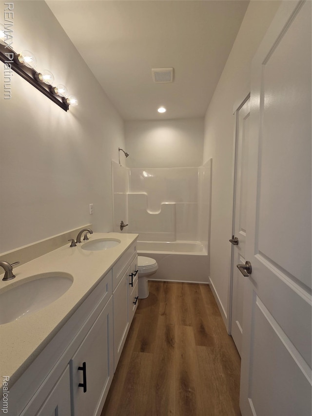 13059 River Rock Pass, Linden, MI 48451 - bathroom featuring wood finished floors, toilet, bathing tub / shower combination, double vanity, and recessed lighting