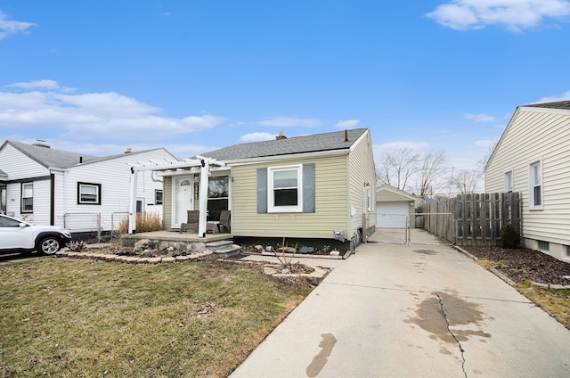 view of front of house with a garage, a gate, fence, and a front lawn