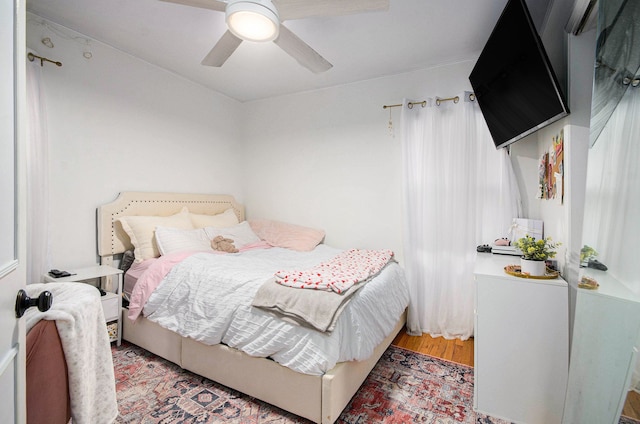 bedroom featuring a ceiling fan and wood finished floors