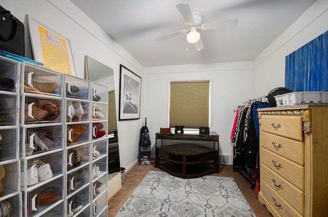 interior space with a ceiling fan and carpet floors