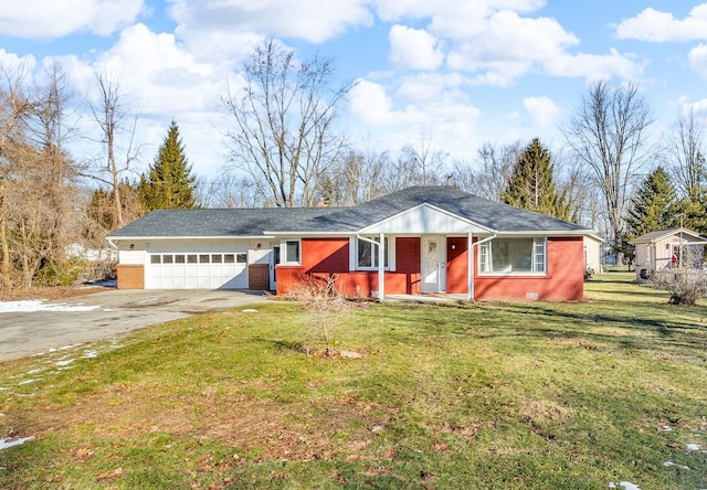 view of front of house with a front yard, an attached garage, brick siding, and driveway