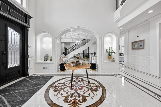 17965 Beck Rd, Northville, MI 48168 - entryway featuring marble finish floor, baseboards, ornamental molding, and a decorative wall