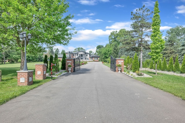 17965 Beck Rd, Northville, MI 48168 - view of road featuring street lights, a gated entry, and a gate