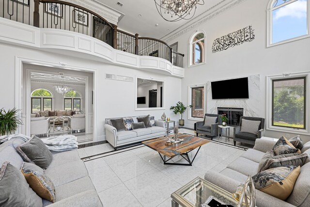 17965 Beck Rd, Northville, MI 48168 - living area with a notable chandelier, a high ceiling, a premium fireplace, baseboards, and ornamental molding