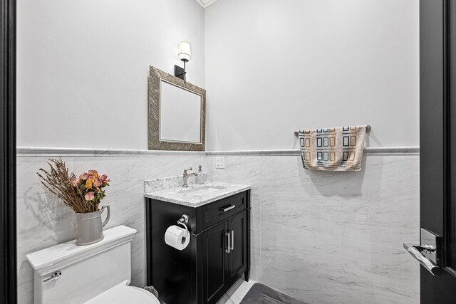 17965 Beck Rd, Northville, MI 48168 - bathroom featuring tile walls, toilet, vanity, and wainscoting