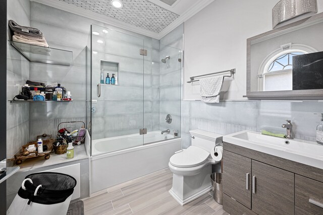17965 Beck Rd, Northville, MI 48168 - full bath featuring bath / shower combo with glass door, crown molding, toilet, vanity, and wood tiled floor