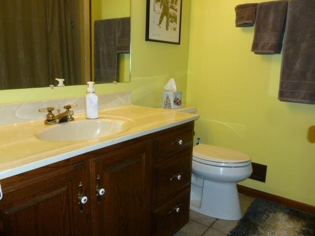 7433 E Maple Ave, Grand Blanc, MI 48439 - bathroom featuring vanity, toilet, tile patterned flooring, and baseboards