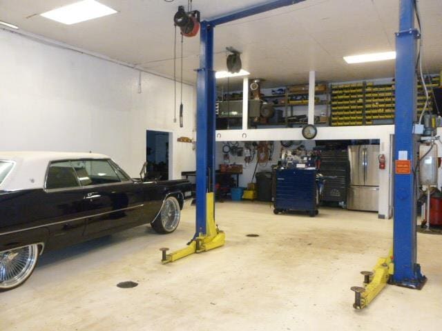 7433 E Maple Ave, Grand Blanc, MI 48439 - garage featuring freestanding refrigerator
