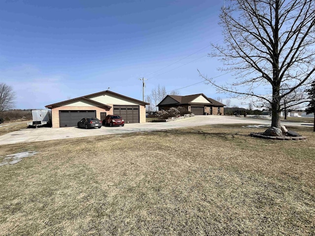 7433 E Maple Ave, Grand Blanc, MI 48439 - view of yard with driveway, an outdoor structure, and a detached garage