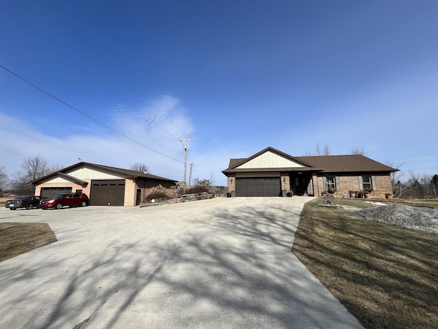 ranch-style home with driveway, an attached garage, and brick siding