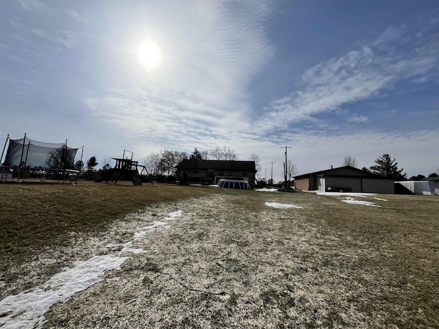 7433 E Maple Ave, Grand Blanc, MI 48439 - view of yard featuring a trampoline