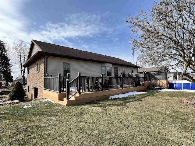 7433 E Maple Ave, Grand Blanc, MI 48439 - back of house with a deck, a yard, and brick siding