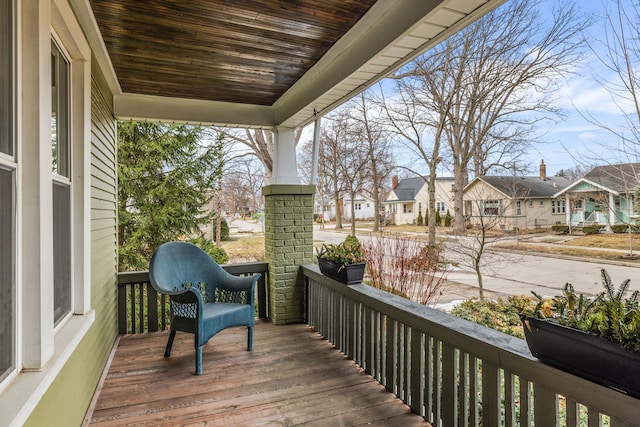 wooden terrace with a porch and a residential view