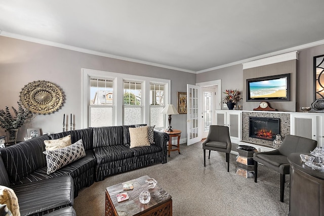 living area with carpet, french doors, crown molding, and a tile fireplace