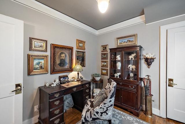 home office featuring baseboards, ornamental molding, and dark wood finished floors