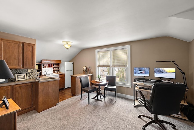 office space with lofted ceiling, baseboards, and carpet