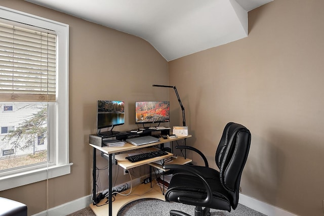 office area featuring vaulted ceiling and baseboards