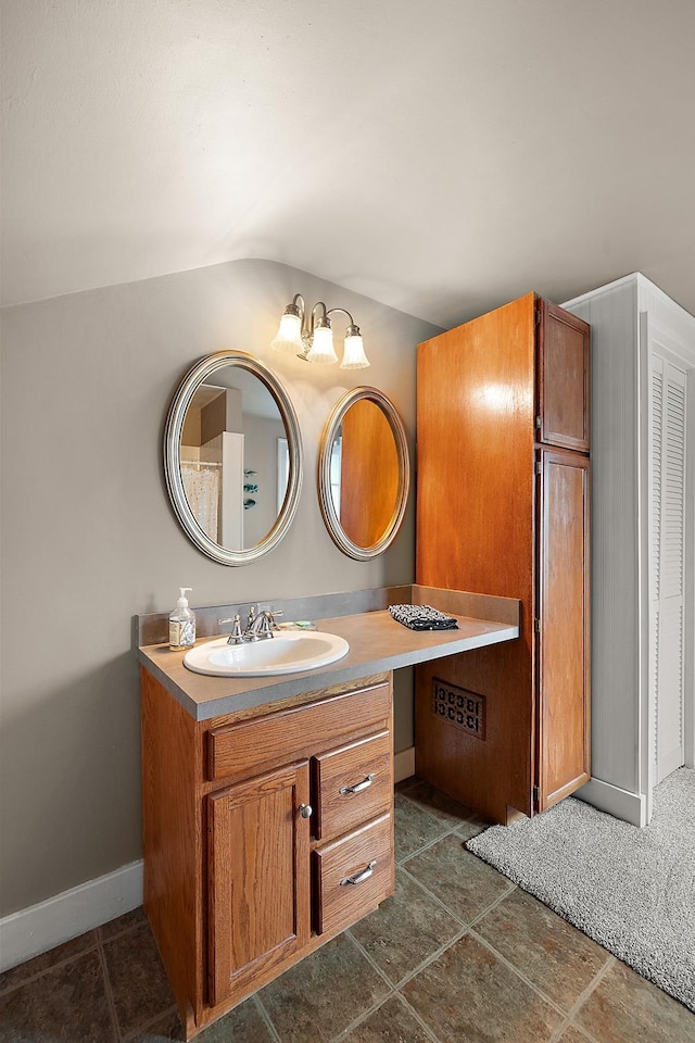 bathroom with tile patterned floors, vanity, and baseboards