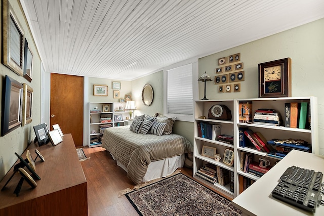 bedroom with wooden ceiling and wood finished floors