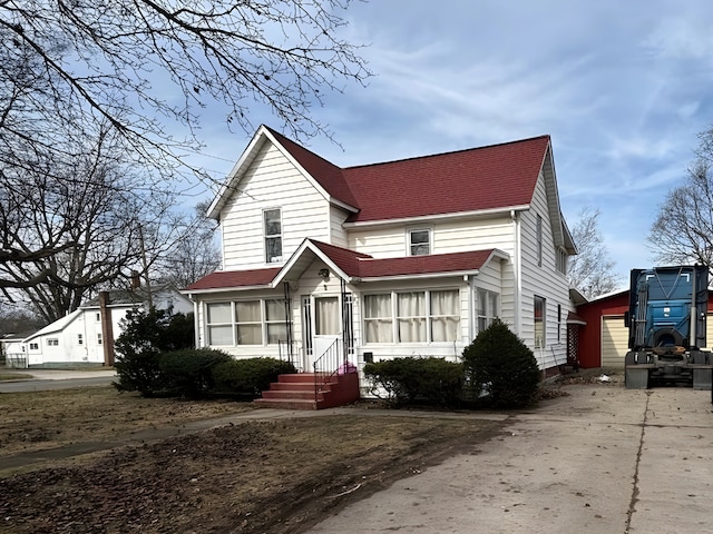 traditional home featuring roof with shingles