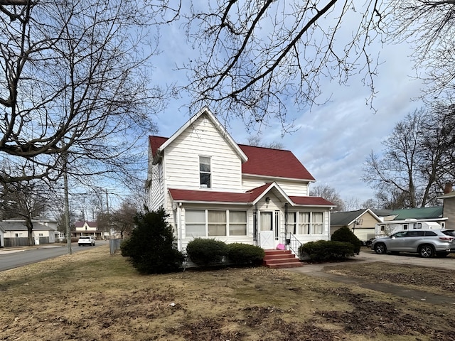 traditional-style home with roof with shingles