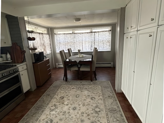 dining area with brick floor, plenty of natural light, and baseboard heating