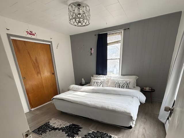 bedroom with baseboards and wood finished floors