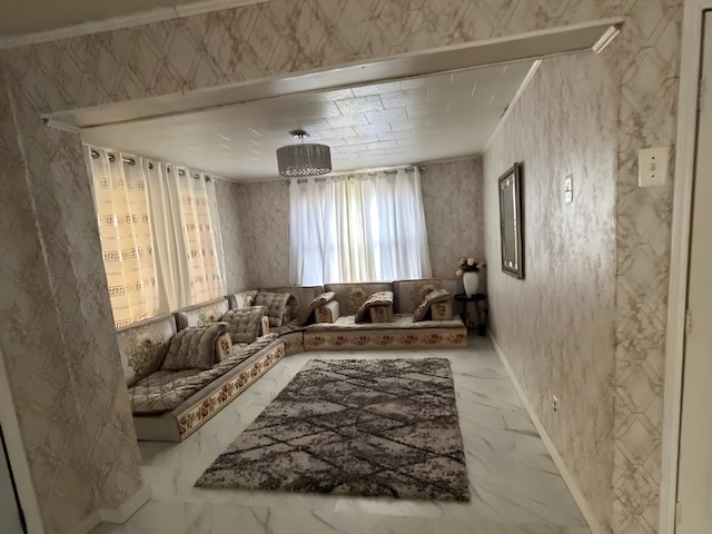 living area featuring marble finish floor and crown molding