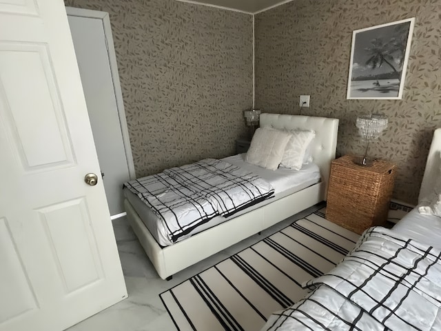 bedroom with marble finish floor, a baseboard radiator, and wallpapered walls