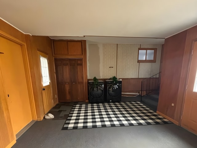 interior space featuring baseboards, washer and clothes dryer, and ornamental molding