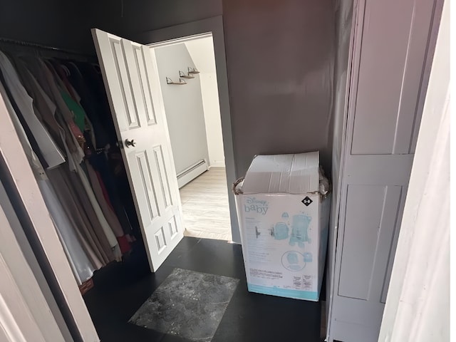 bathroom with a baseboard radiator and wood finished floors