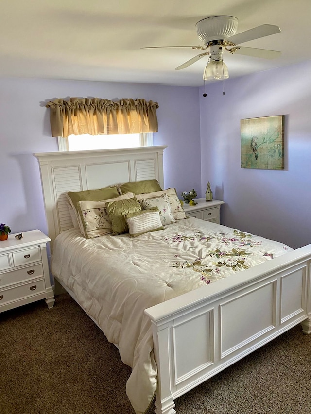 bedroom with dark carpet and a ceiling fan