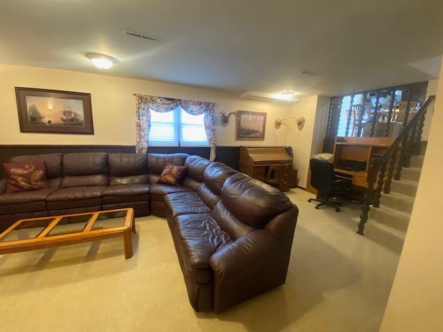 living room featuring carpet, visible vents, and stairs