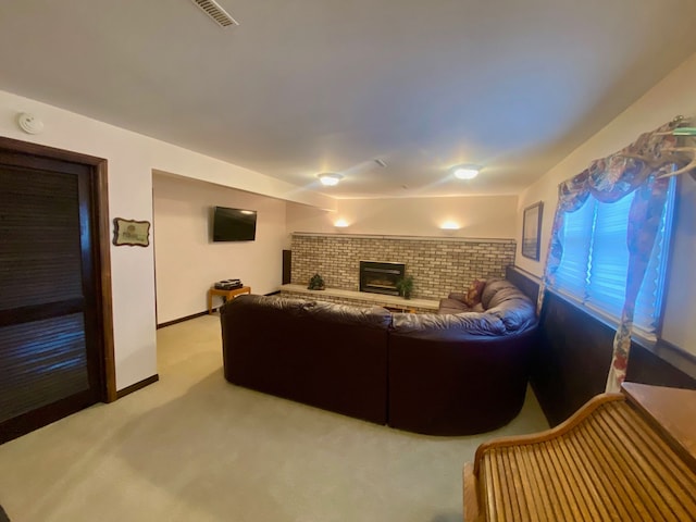 living room featuring light carpet, a brick fireplace, baseboards, and visible vents