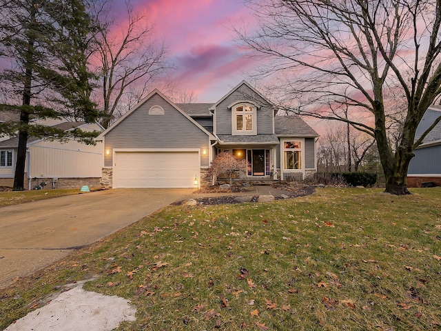 view of front facade featuring a yard, concrete driveway, a garage, and a shingled roof