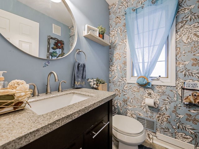 bathroom featuring visible vents, toilet, and vanity