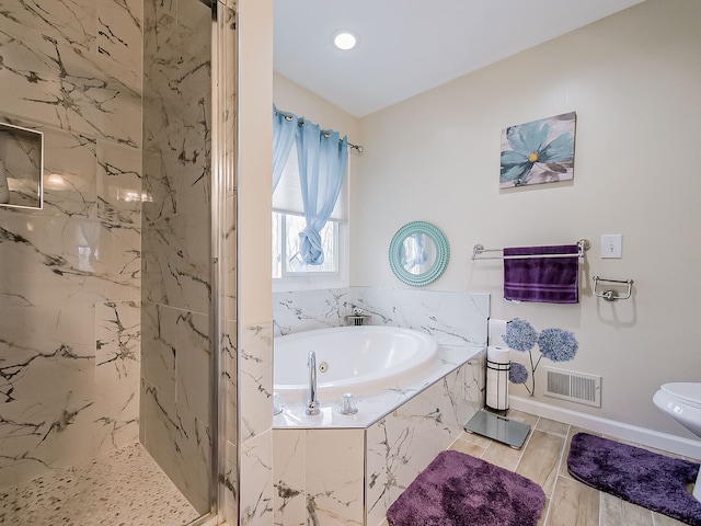 bathroom featuring baseboards, visible vents, a marble finish shower, a garden tub, and toilet