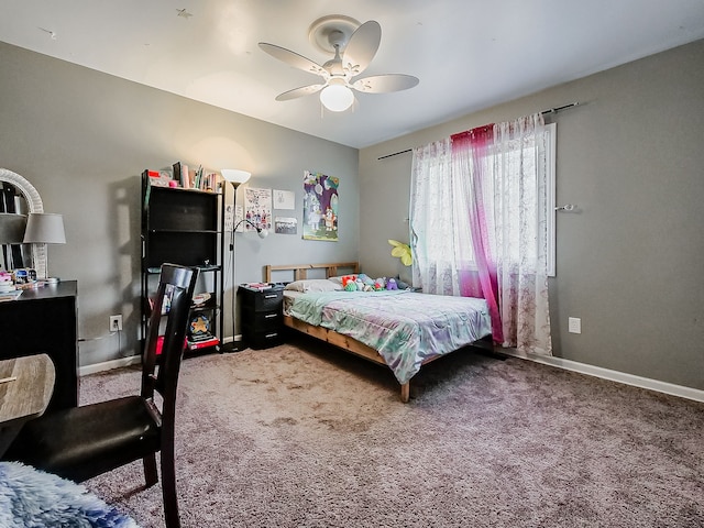 carpeted bedroom with a ceiling fan and baseboards