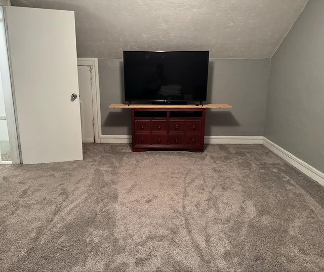 living room with lofted ceiling, carpet floors, a textured ceiling, and baseboards