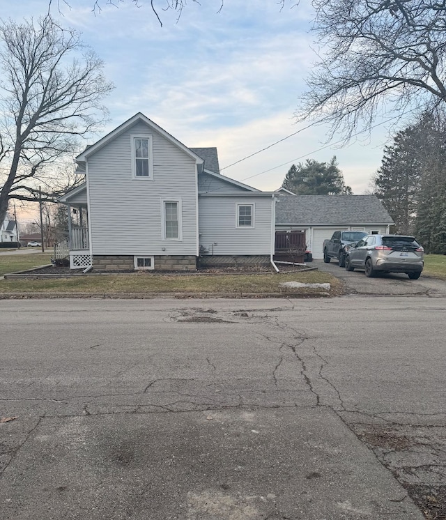 view of side of home featuring an attached garage