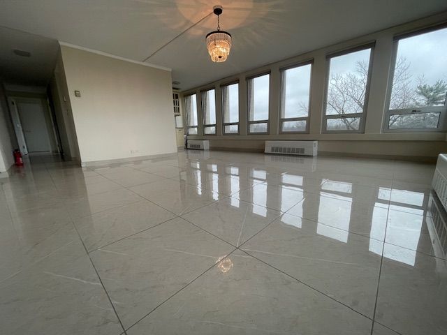 empty room with radiator and marble finish floor