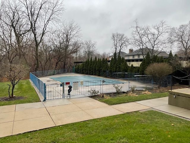 pool featuring a yard, fence, and a patio